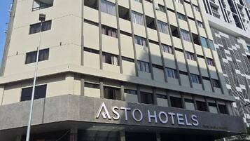 A multi-story hotel building with a modern design, featuring a prominent 'ASTO HOTELS' sign at the ground level.