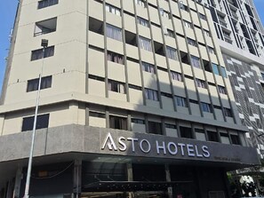 A multi-story hotel building with a modern design, featuring a prominent 'ASTO HOTELS' sign at the ground level. - asto hotel (Kuala Lumpur)