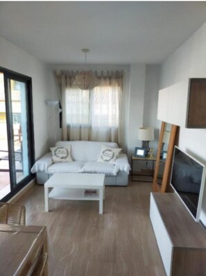 A modern living room with a sofa, coffee table, and TV stand. - PENTHOUSE IN MORAIRA, WITH A LARGE TERRACE   (VC)