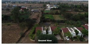 An aerial view of a rural area with houses, fields, and a hilly landscape in the background. - The Quade Villa By Spandan Holiday Homes (Anjaneri)