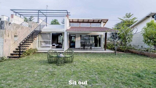 A modern house with a glass extension, outdoor seating, and a staircase. - The Quade Villa By Spandan Holiday Homes (Anjaneri)
