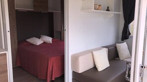 Ein gemütlicher Raum mit einem Bett und einer Schlafcouch, beide mit Kissen.