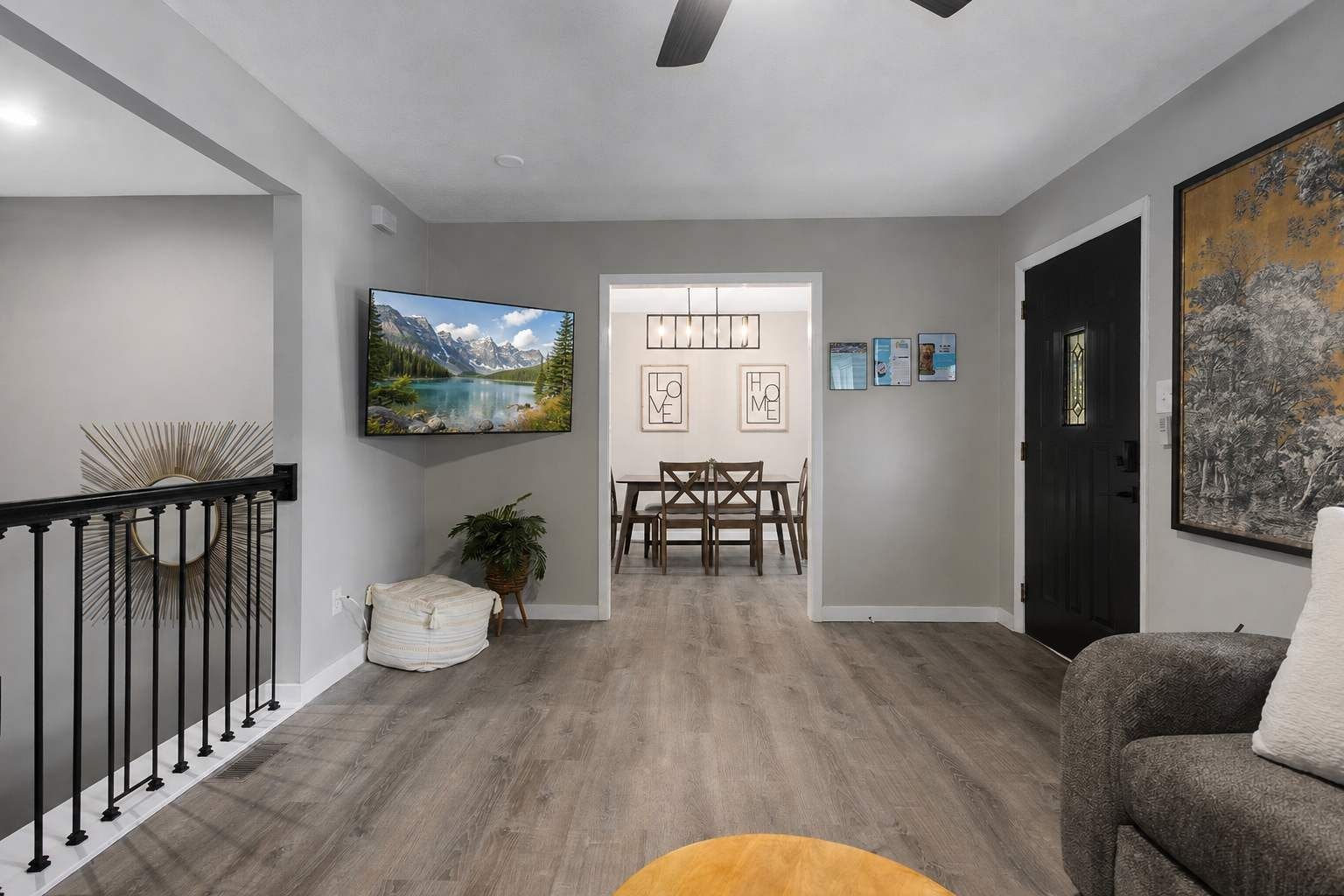 A modern interior with a dining area, a living room, and a staircase.