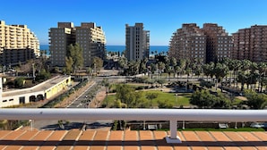 A coastal cityscape with high-rise buildings, a clear blue sky, and a view of the sea. - ACV - Apartamentos Torremar (Oropesa del Mar)