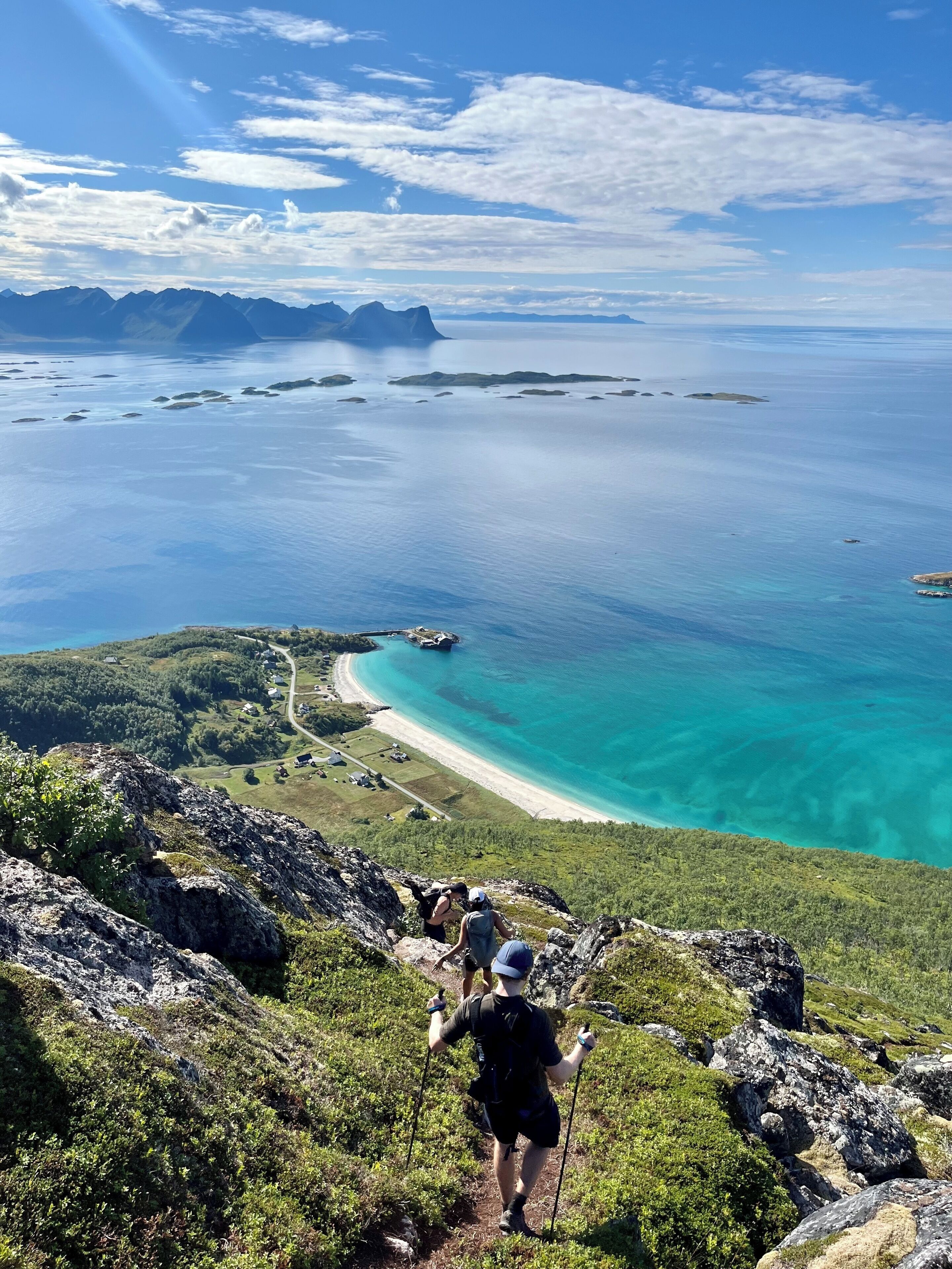 A mountainous landscape with a clear view of a coastline and a beach.