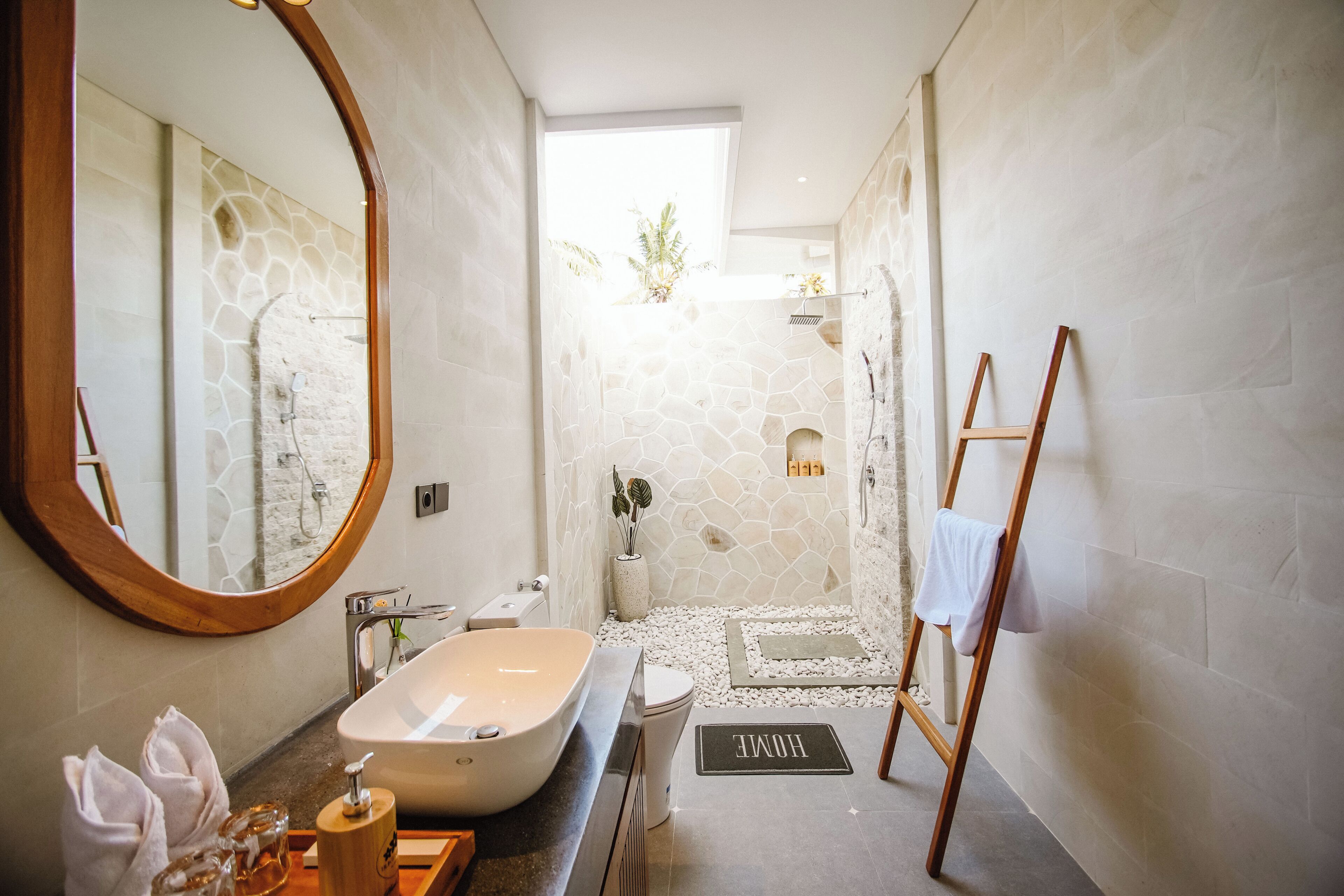 Une salle de bain moderne avec une baignoire sur pieds, un grand miroir et un espace douche.
