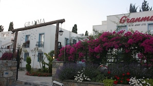 A building with a sign reading "GRAMMA" and another sign for "GRAMMA BUTIK APART OTEI". - Granma Butik Apart Otel (Bodrum)