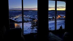 A room with large windows overlooking a snowy landscape during twilight. - Chalet /Hytte with dream view, pure relaxation in the beautiful nature (Telemark)