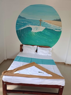 A bed with a wooden frame, white bedding, and a painting of a beach scene above it. - Salvador Beach Cafe (Arambol)