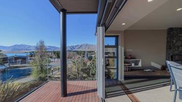 A modern interior with a view of mountains and a pool.