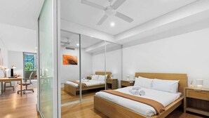 A modern hotel room with a large bed, a desk, and a chair. - Central Art-filled 2 Beds With Balcony Aircon (Sydney)