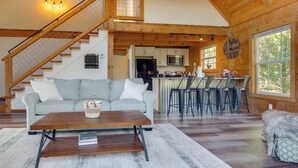 A spacious living area with a staircase, a kitchen, and a dining area. - Hike & Unwind, Peaceful Wooded Retreat in Newport (Newport)