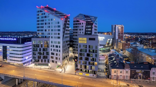 A modern urban area with distinctive buildings, including a hotel named "TECHNOPOLIS" and another building with a sign "SRI OPAALI." - 12th Floor Sauna Retreat with Views (Tampere)