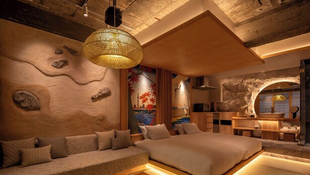 A modern bedroom with a large bed, a sofa, and a wooden bench. - Walking distance from Asakusa, Japanese modern in Asakusa｜ 1 floor for private use｜ Ideal for couples and honeymooners｜ 30 square meters｜ Max 4 people (Matsugaya, Taito City)