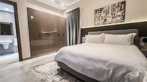 Luxury Suite, 1 Bedroom, City View | In-room safe, desk, laptop workspace, iron/ironing board