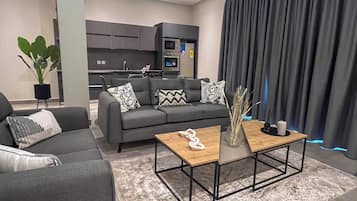 Luxury Suite, 2 Bedrooms, City View | In-room safe, desk, laptop workspace, iron/ironing board