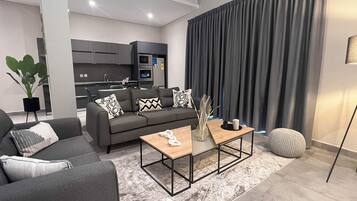 Luxury Suite, 1 Bedroom, City View | In-room safe, desk, laptop workspace, iron/ironing board