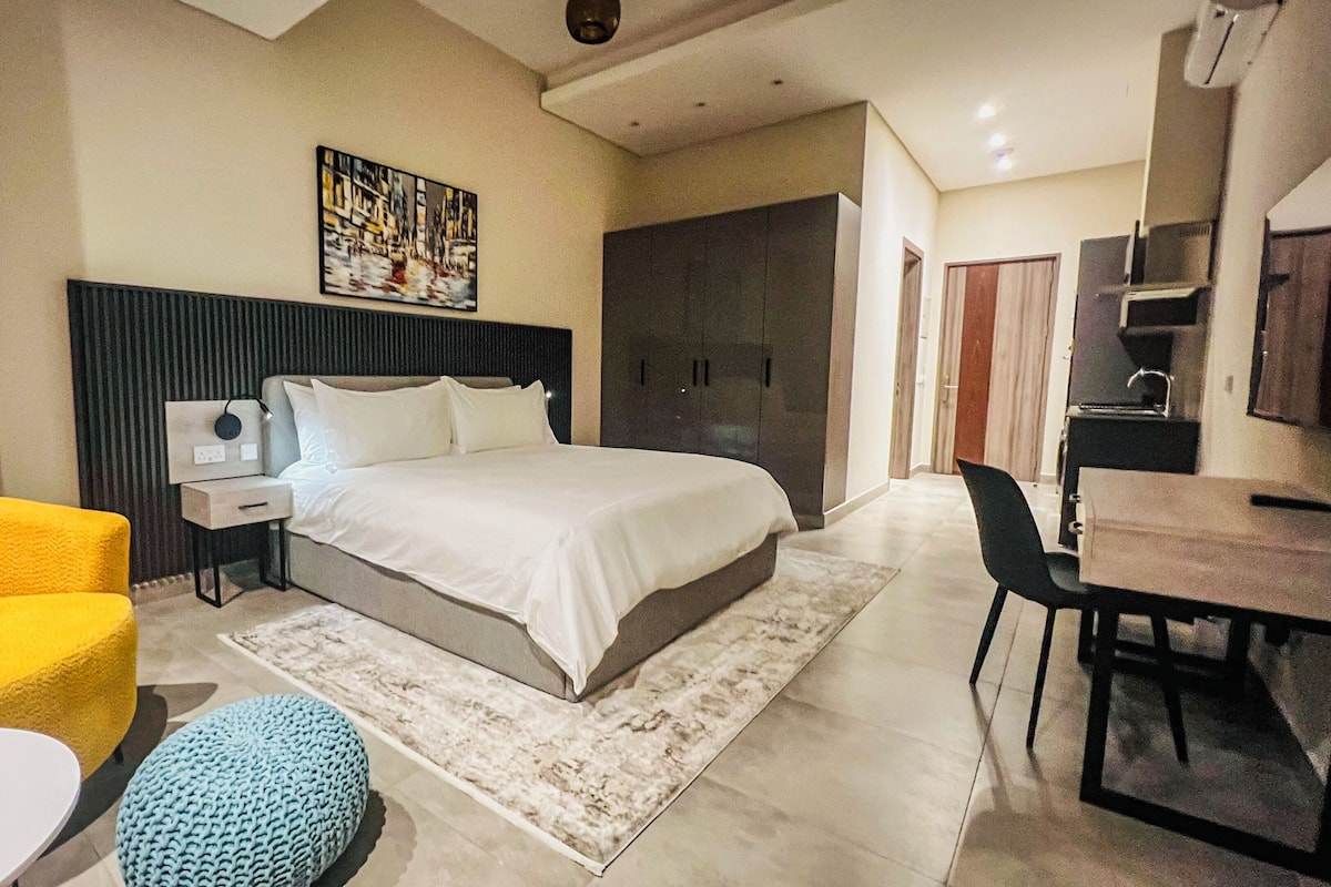 Luxury Studio Suite, City View | In-room safe, desk, laptop workspace, iron/ironing board