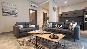 Luxury Suite, 2 Bedrooms, City View | In-room safe, desk, laptop workspace, iron/ironing board