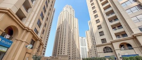 A high-rise building with a modern architectural design, surrounded by other tall buildings.
