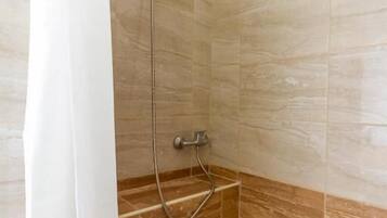 Shower, hair dryer, towels, toilet paper