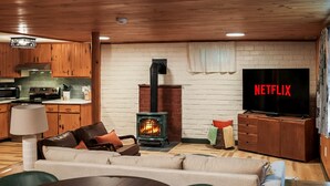 A cozy living room with a fireplace, a television, and a sofa. - 4BR Mtn Retreat w/ Hot Tub, Game Rm & 2 Kitchens – 15 Mins to North Conway! (Conway)
