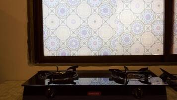 A gas stove with a patterned backsplash.