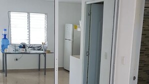 A spacious room with a sliding glass door leading to a kitchen area. - Villa Tropical Studio No. 9, near the beach, Cabarete (Cabarete)