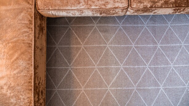 A close-up of a textured, diamond-patterned floor.
