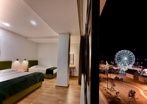 A modern hotel room with a large window overlooking a Ferris wheel. - Hotel Republika Berat (Velabisht)