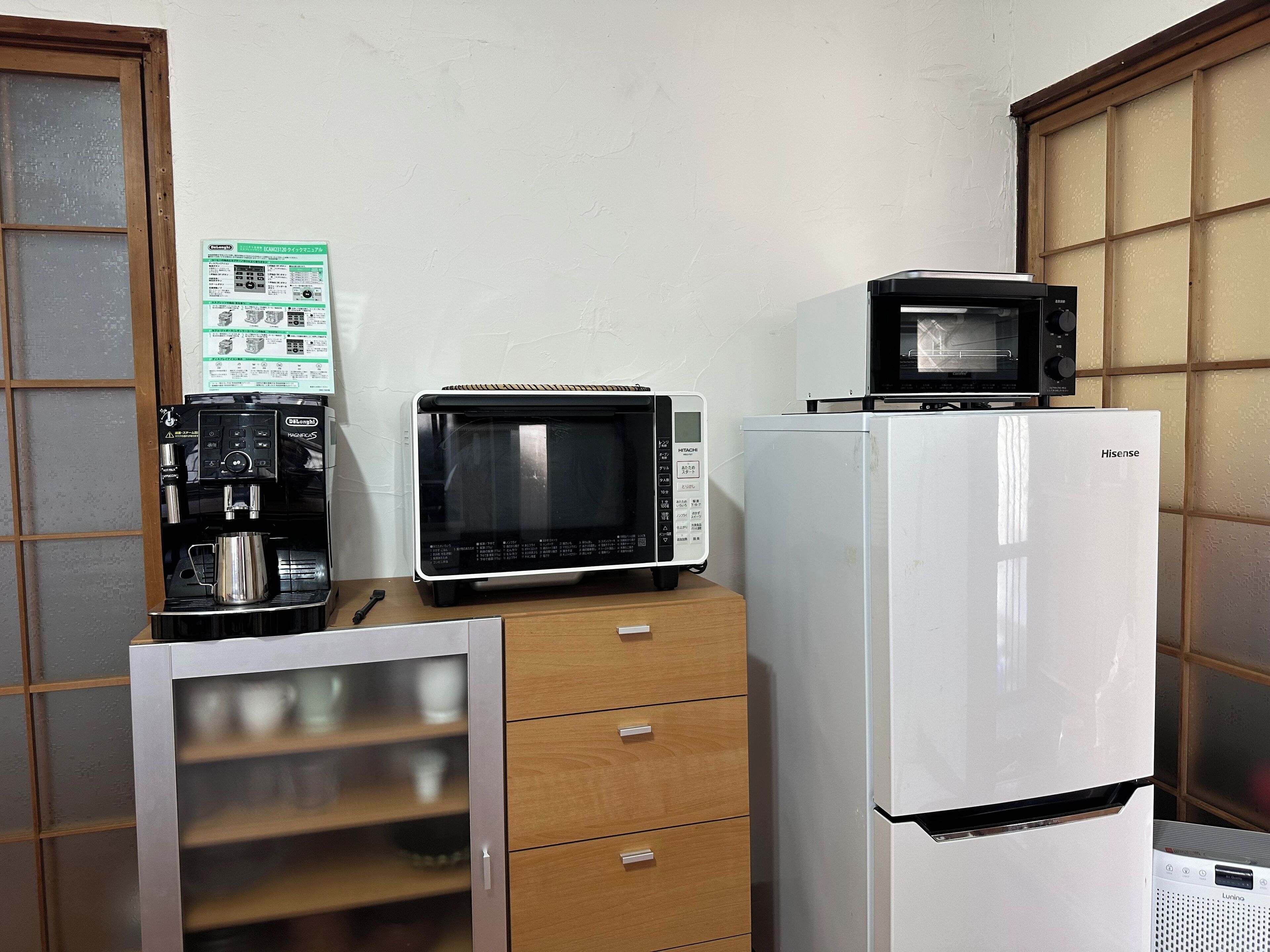 A kitchenette with a coffee maker, a microwave, and a refrigerator.