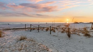 A beach with a wooden fence and sand dunes. - Beach House - C Shucker by PHG (Mexico Beach)