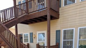 A wooden staircase leading to a balcony with a view of a house. - KLTD1  Klonteska Manor  An unforgettable mountain getaway! (Beech Mountain)