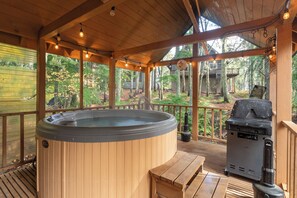 A wooden deck with a hot tub, grill, and wooden benches. - Third night free on stays before 9/14/26 (Government Camp)