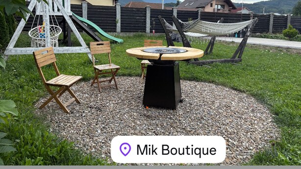 A playground with swings and a slide, a round table with chairs, and a hammock. - Mik Chalet. Pet friendly (Săcele)