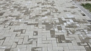 A paved courtyard with a brick pattern, surrounded by buildings and a mountain backdrop. - Mik Chalet. Pet friendly (Săcele)