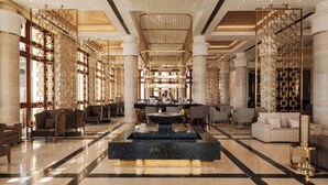 A spacious lobby with a central fountain, seating areas, and a bar. - Al Kasr Sahl Hasheesh-Ultra All-Inclusive (Sahl Hasheeh)