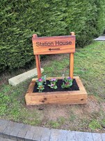 A wooden sign with the text "Station House" and an arrow pointing to the left.