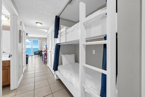A room with bunk beds, a bathroom with a shower, and a view of the sea. - ☀️Gulf Front - 2 Beach Front Pools - The Osprey at Seychelles 2107 Resort☀️ (Panama City Beach)