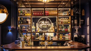 A bar area with a variety of liquor bottles, a bar counter, and a sign that reads "CASABLANCA Bar & Lounge".