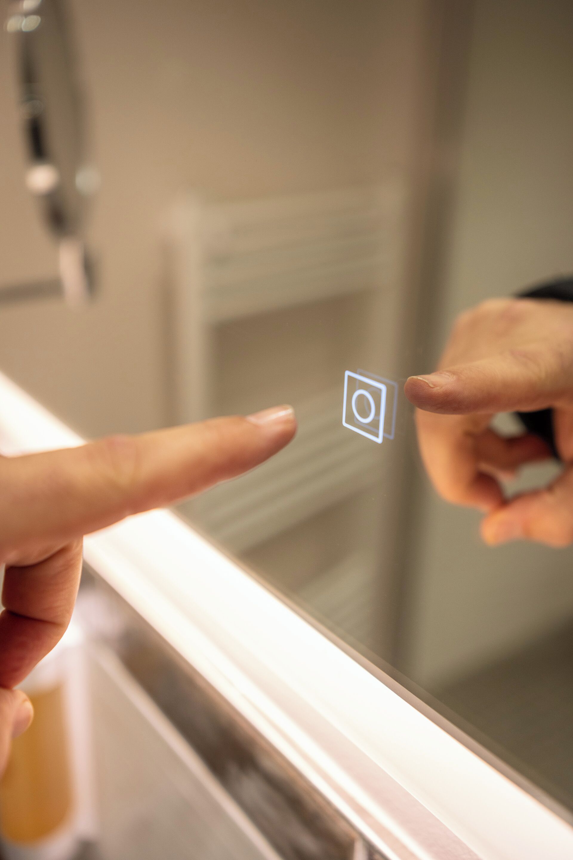 A hand pointing at a small square icon on a reflective surface.