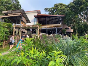 A building with a bamboo structure and a modern annex. - The View Hostel  (Ko Phi Phi)