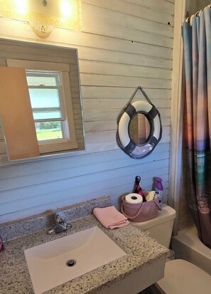 A bathroom with a granite countertop sink, a mirror, a toilet, and a bathtub. - Suite 3 - Older/Simple/Rustic/No Frills/Budget 2BR - Near Cabot Beach Park (Kensington)