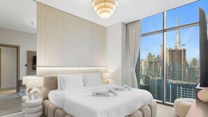 A modern hotel room with a large bed, a city view, and a unique wall design. - Skyline Escape 2 bedroom with Burj Khalifa View (Business Bay)