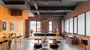 A modern indoor space with a pool table, dining area, and large windows. - Cove Amartha (South Jakarta)
