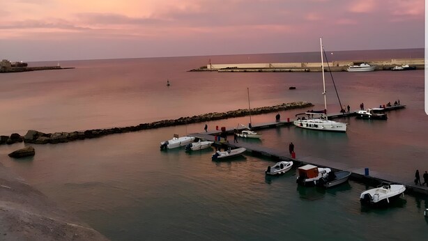 A harbor with boats docked, a pier, and a distant shoreline. - Holiday Home 'Debby' with Private Terrace, Wi-Fi and Air Conditioning (Otranto)
