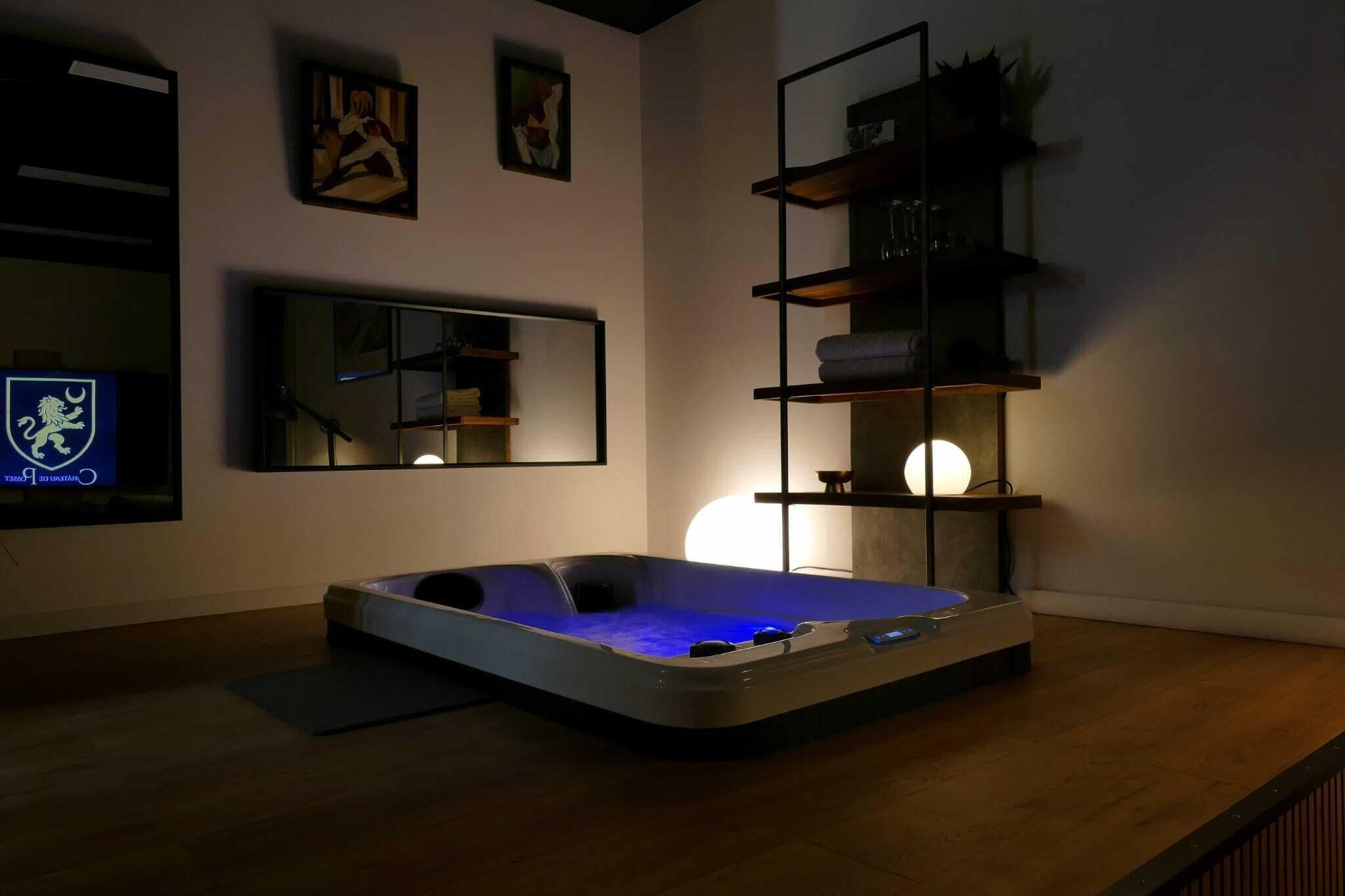 A modern room with a hot tub, a large mirror, and shelves with decorative items.