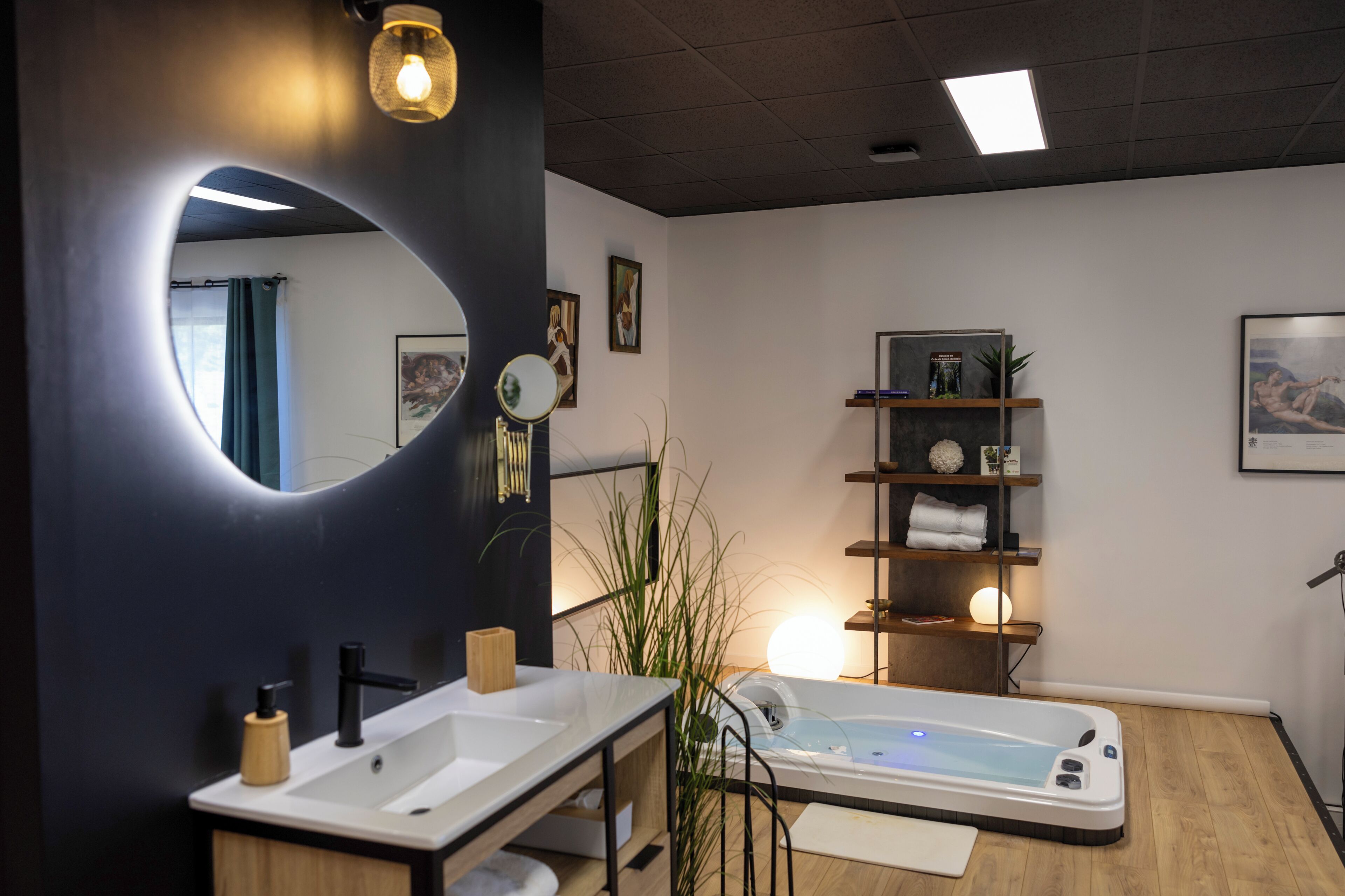 A modern bathroom with a large mirror, two sinks, a bathtub, and shelves with toiletries.