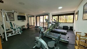 A gym with treadmills, elliptical machines, and weightlifting equipment. - Lorena 1157 (São Paulo)