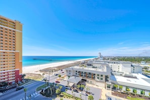 A coastal hotel with a beach view, a pier, and a parking area. - Calypso 3-1006 (Panama City Beach)